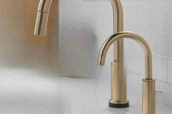 Automatic bathroom faucet and automatic soap dispenser together in a commercial sink system.