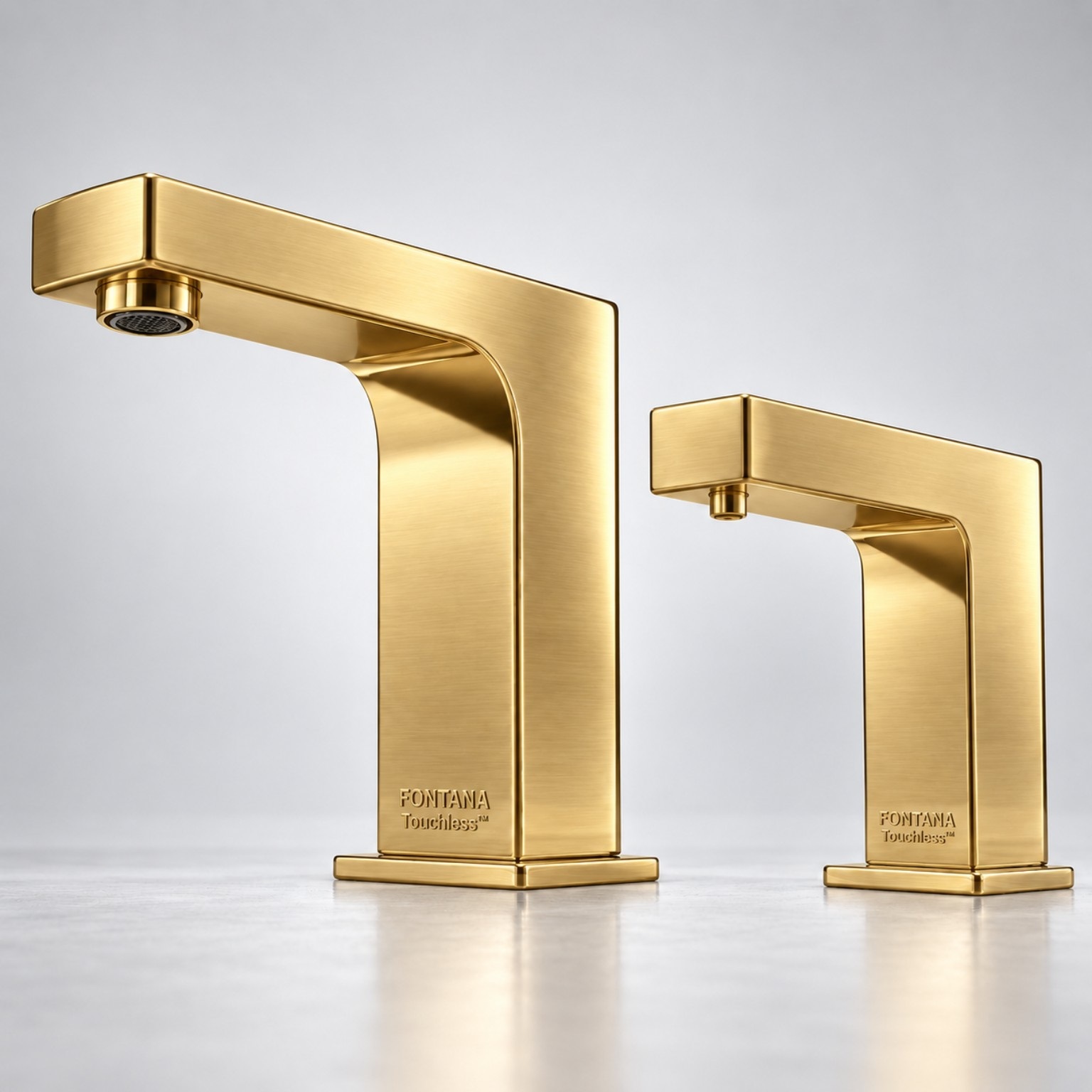 Brushed gold angular faucet and dispenser pair for luxury bathroom finish coordination.