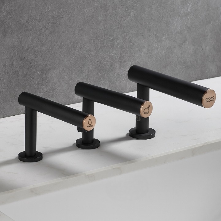 Matte black deck-mounted fixture arrangement for a coordinated commercial washstation.